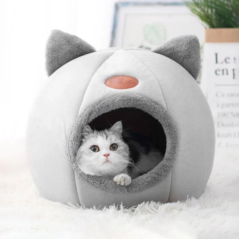 Cozy gray cat cave bed with cat ears, perfect for cats to snuggle and sleep comfortably.