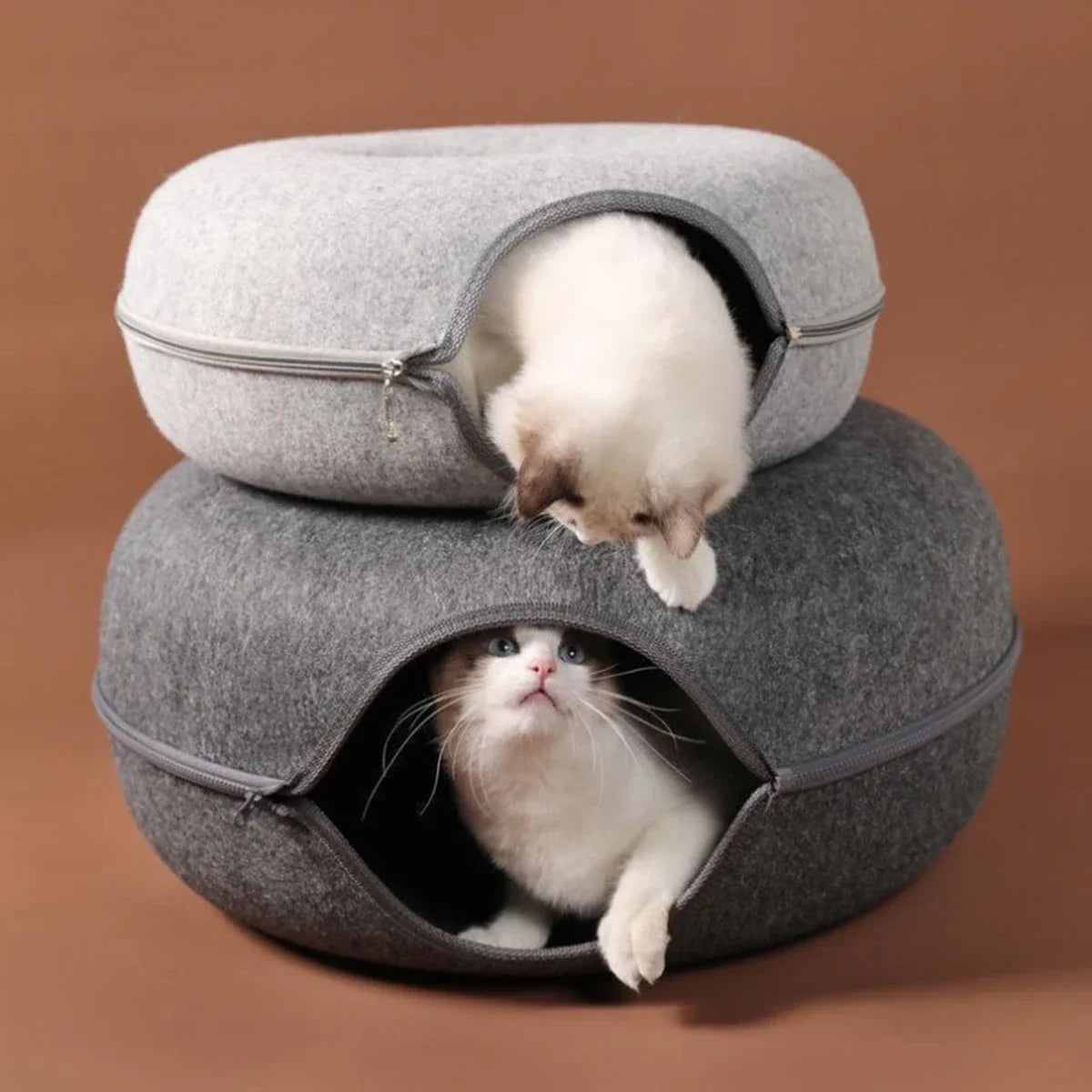 Two cats in cozy gray felt cat beds, one peeking out, perfect for pet comfort and play.
