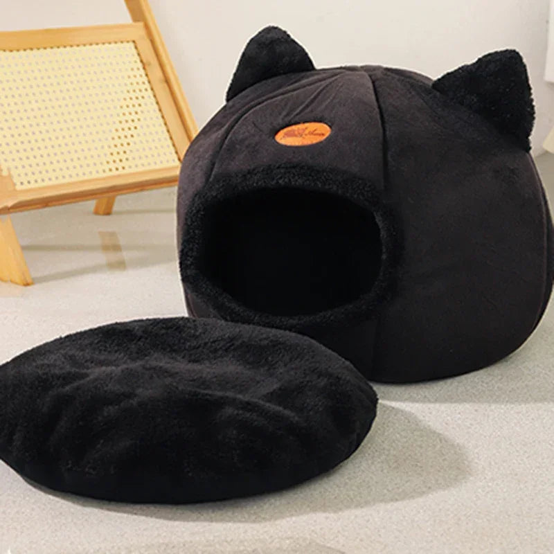 Cozy black cat cave bed with plush ears and matching cushion, perfect for cats and small dogs.